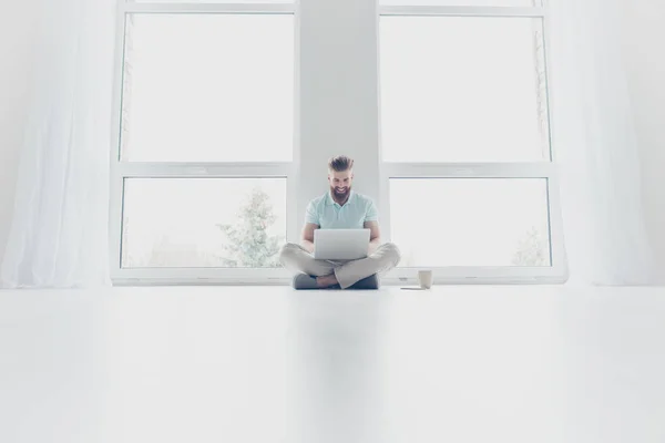 Young successful freelancer is working at home, sitting on the f