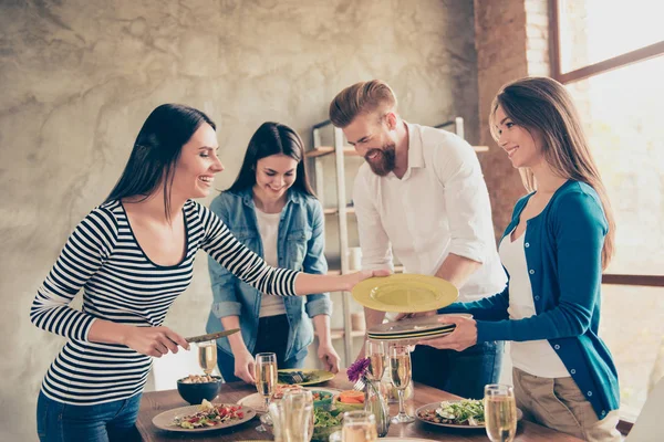 Teamarbeit. Freunde putzen einen Tisch mit Tellern und Gläsern — Stockfoto