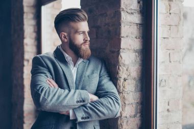 Close up portrait of handsome bearded young man in suit leaning  clipart