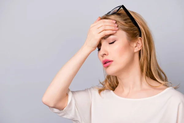 Mujer triste con el pelo rubio tocando su frente debido a havi —  Fotos de Stock