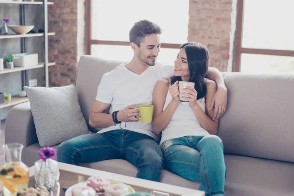 True love. Beautiful couple in casual outfit is sitting on moder