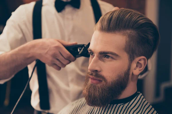 Close up of a hairdresser`s work for a handsome young guy at the — Stock Photo, Image