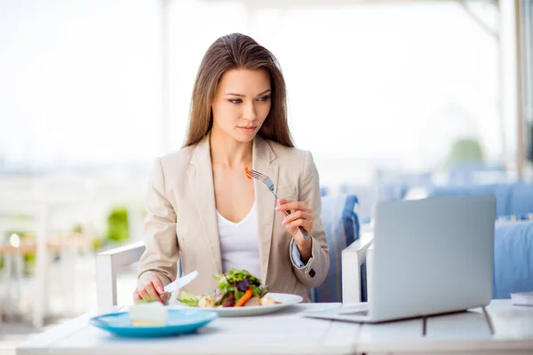 Pensive young business lady is having her lunch at the roof top