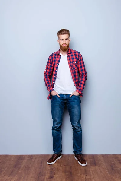 Successful young stylish red bearded freelancer in bright casual