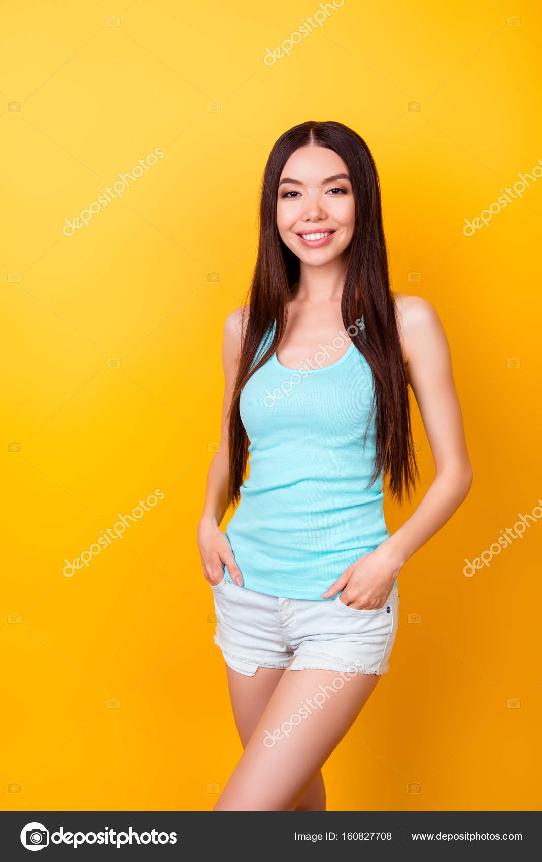 Young cute korean lady in summer outfit standing in pose on