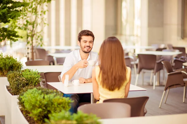 Young cheerful guy on a date in cafe outdoors, smiling, talking — Stock Photo, Image