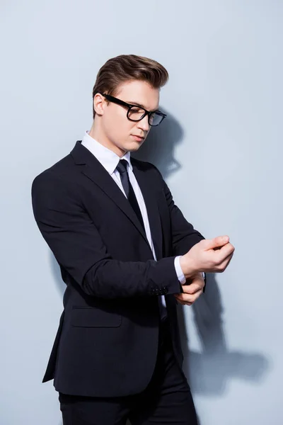 Young handsome businessman lawyer in a suit is fixing his cuffl — Stock Photo, Image