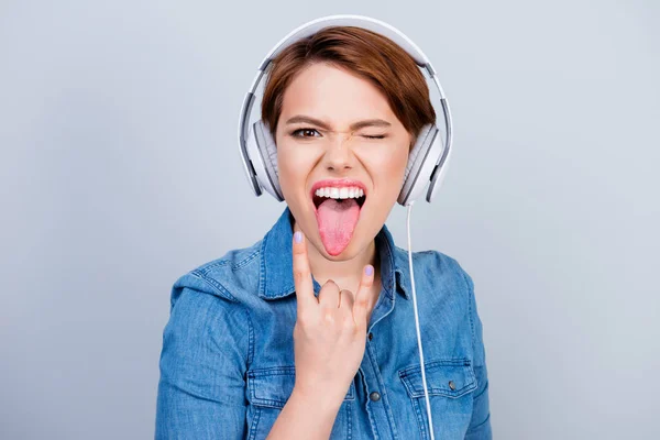 Young woman in jeans shirt in headphones listening to music show — Stock Photo, Image