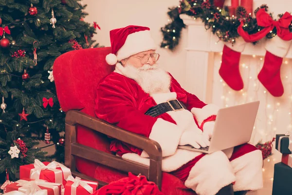 Close up of santa, study list of children 's wishes and gifts on — стоковое фото