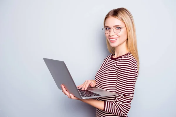 Cute charming confident and smiling young lady is holding laptop — Stock Photo, Image