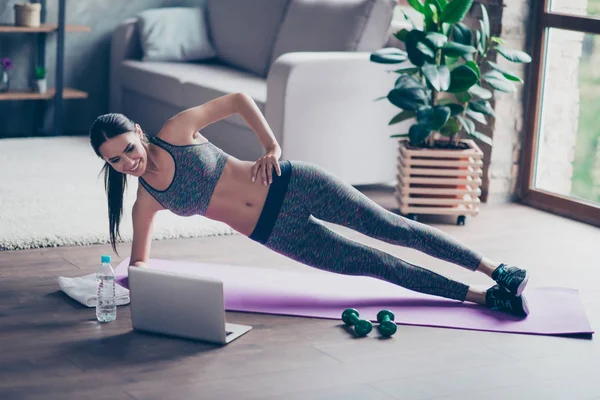 Bela mulher alegre desportiva está fazendo exercício de prancha lateral. Sh... — Fotografia de Stock