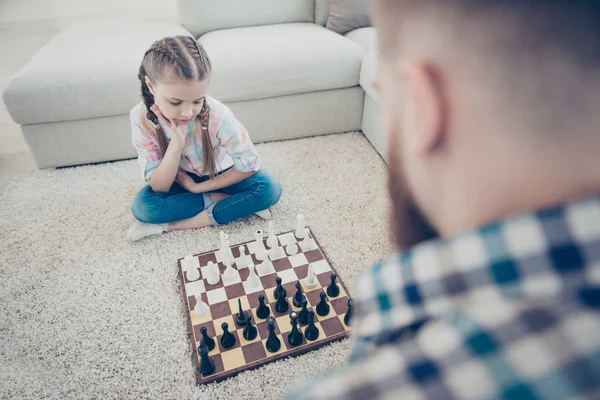 Minded ponder smart schoolgirl sitting with crossed legs on carp