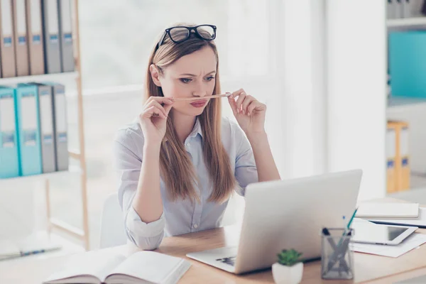 Portrait of funny, comic, childish woman holding pencil between — Stock Photo, Image