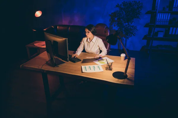 Nice attractive stylish lonely single lady top executive manager marketer financier analyzing startup financial result preparing daily report at night dark industrial interior style work place station — ストック写真