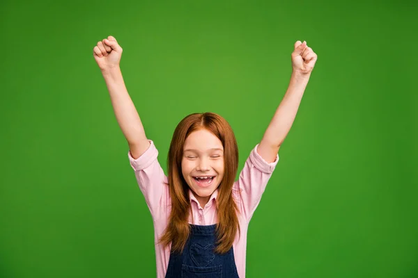 Photo of little crazy ginger schoolchild in front of blackboard celebrating raise fists rejoicing summer beginning wear denim overall pink shirt isolated green background — Stock Photo, Image