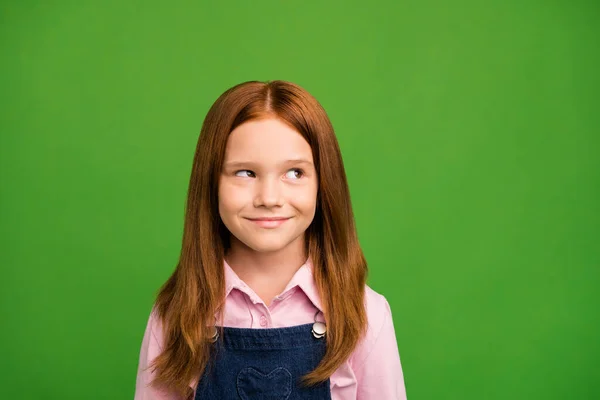 Closeup photo of little ginger schoolchild in front of blackboard looking empty space thinking over answer teacher question wear denim overall pink shirt isolated green background — Φωτογραφία Αρχείου