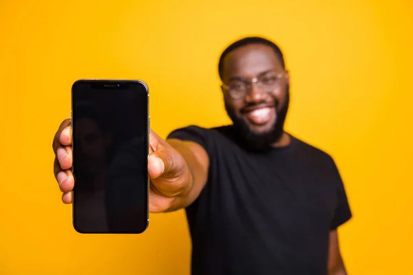Pozitif afro amerikalı adamın portresi akıllı telefon gösteriyor modern teknoloji aleti reklamları sarı arka planda izole edilmiş günlük kıyafet giyiyor. — Stok fotoğraf