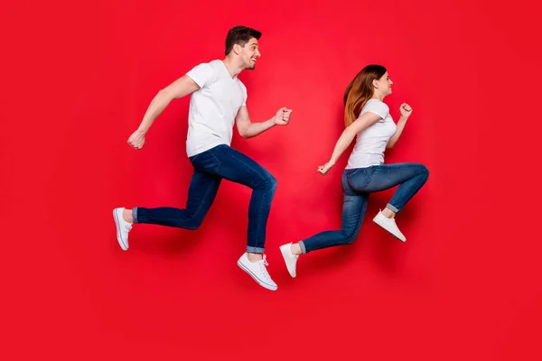 Full length body size side profile photo of cheerful positive running girl boy wearing jeans dżinsy obuwie biały t-shirt uśmiechając się toothily izolowane żywe tło kolor skoki — Zdjęcie stockowe