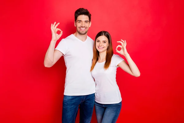 Photo of cheerful positive nice cute charming couple boyfriend girlfriend showing ok sign in jeans denim white t-shirt smiling toothily hugging isolated vivid color background — Stock Photo, Image