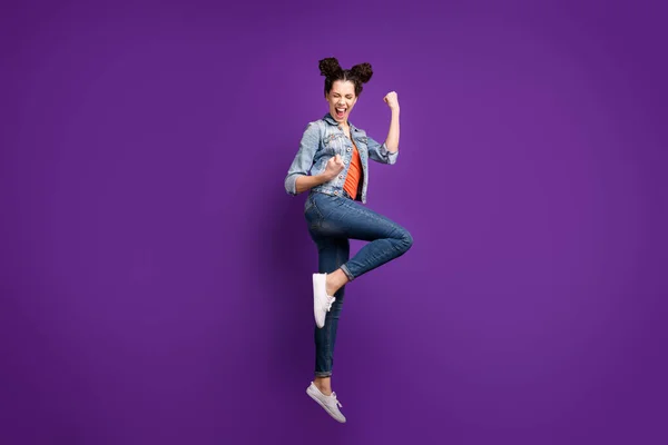 Full body profile photo of funny student lady jumping high ecstatic mood screaming hooray wear casual denim stylish outfit isolated purple color background