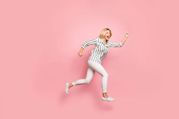 Full length body size side profile photo of cheerful positive cute funny nice girlfriend screaming during run to shopping mall for sales isolated pastel color background in white pants