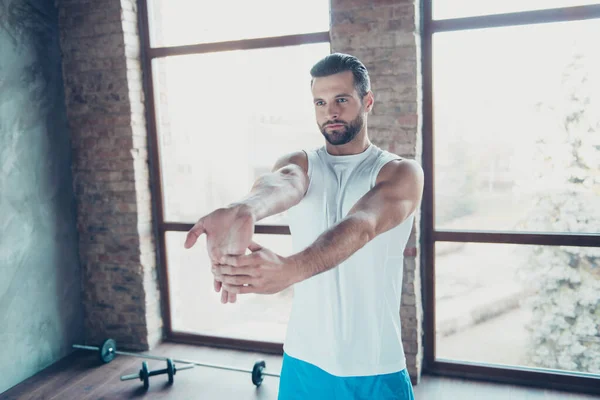 Photo of macho guy preparing to morning training stretch hand fingers muscles sportswear tank-top shorts sneakers training house studio big windows indoors — Stock Photo, Image