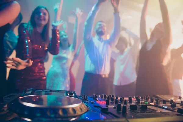 Dj performing loud stereo sound rhythm trance techno electronic style set music for attractive stylish cheerful positive crowd having fun visiting concert at fashionable modern nightclub