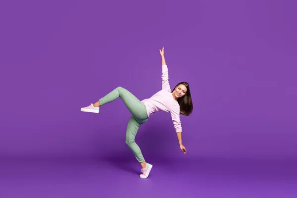 Full length body size side profile photo of cheerful beautiful attractive pretty sweet girl dancing like swan with hands spread balancing standing on one foot isolated purple vivid color background — Stock Photo, Image