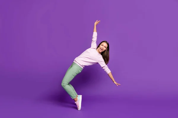 Full length body size photo of cheerful cute nice attractive girlfriend daincing while balancing on her toes with emotions on face isolated over purple vivid color background — Stock Photo, Image