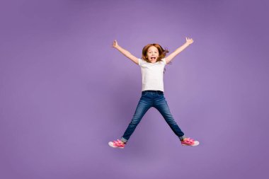 Full length photo of funny small foxy lady jumping high rejoicing making star shape in air cheerful crazy mood wear casual t-shirt jeans isolated purple background clipart