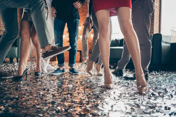 Cropped close-up photo of slim legs girls guys meeting rejoicing dance floor x-mas party glitter flying wear luxury formalwear red dress silver skirt pants restaurant indoors