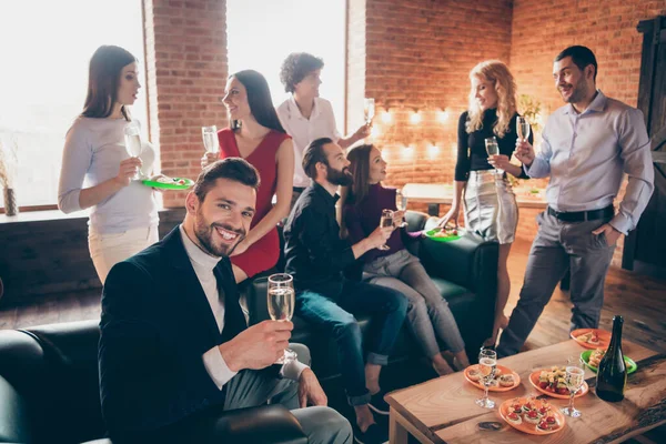 Photo of group festive birthday party chatting handsome guy raising glass drink golden wine eating snacks wear formalwear restaurant sitting near table indoors — Stock Photo, Image