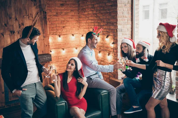 Photo of six members group x-mas party couples people friendship buddies clinking wineglasses drink golden wine wear formalwear santa hats deer horns indoors — Stock Photo, Image