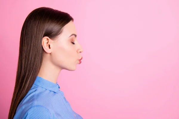 Foto de perfil de la increíble dama que envía un beso de aire al espacio vacío humor coqueto y ojos cerrados usan camisa de puntos azul aislado de color rosa de fondo —  Fotos de Stock