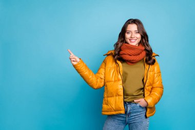 Photo of pretty millennial lady indicating finger empty space sales manager wear modern stylish autumn windbreaker jeans scarf pullover isolated blue color background clipart