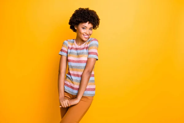 Photo of pretty dark skin lady shy person coquettish mood flirting with handsome guy wear casual striped t-shirt trousers isolated yellow background — Stock Photo, Image