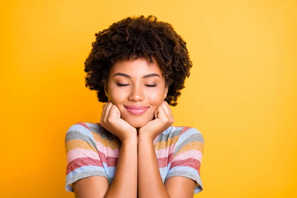 Photo of cheerful cute charming fascinating black youngster with eyes closed enjoying her free time isolated over yellow vivid color background — Stock Photo, Image