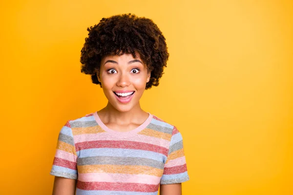 Photo of beautiful dark skin wavy lady looking shopping banner overjoyed with discount prices wear casual striped t-shirt isolated yellow background — Stockfoto