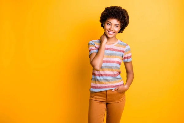 Photo of gorgeous fascinating girl holding hand in pants pocket posing near empty space smiling toothily beaming isolated over vibrant color background — Stock Photo, Image