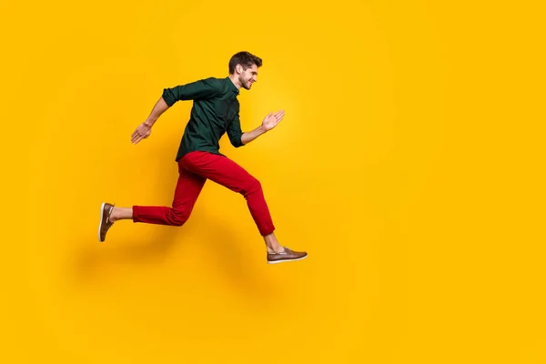 Full body profiel side photo of positive cheerful funky guy hear about wonderful black Friday sales jump run want be first wear casual style outfit isolated over yellow color background — Stockfoto