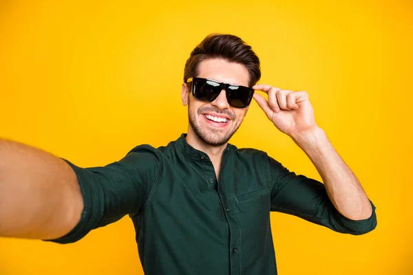 Close up photo of positive cheerful guy rich wealthy son of millionaire travel trip blogging feel candid have fun tale selfie touch spectacles wear modern clothing isolated yellow color background — Stock Photo, Image