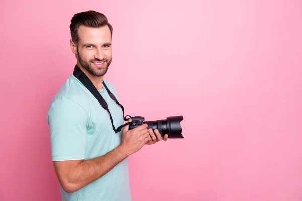 Profile side photo of positive man have rest relax spring vacation want shooting hold big dslr camera wear modern clothing isolated over pastel color background — Stock Photo, Image