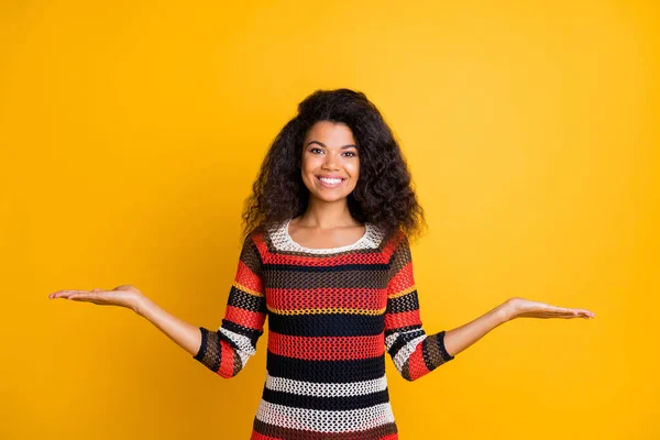 Portrait of her she nice-looking attractive charming cheerful cheery wavy-haired girl wearing knitted sweater weighing invisible objects isolated on bright vivid shine vibrant yellow color background — Stock Photo, Image