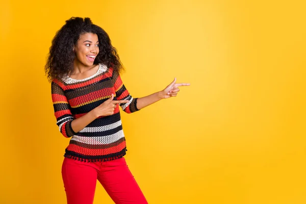 Retrato de ella ella agradable atractivo alegre alegre alegre chica de pelo ondulado en suéter de punto señalando a un lado solución seguir suscríbete aislado en brillante brillo vivo vibrante color amarillo fondo — Foto de Stock