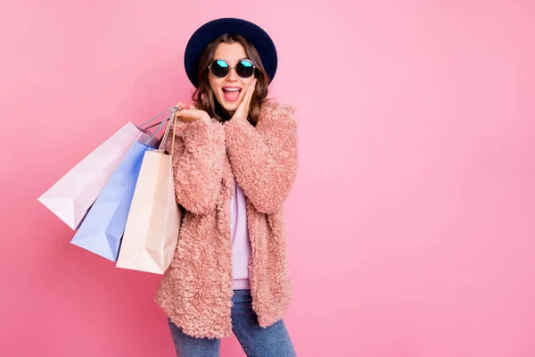 Photo of pretty lady hold carry many packs shopper tourism abroad look unbelievable sale prices hand on cheek store wear jacket sun specs hat jeans isolated pink background — Φωτογραφία Αρχείου