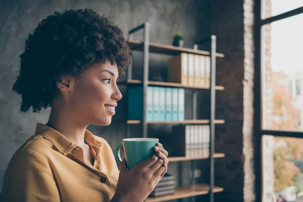 Close-up profiel zijkant foto van dromerig Afrikaans meisje bedrijf rust houden warm espresso cup droom look venster in kantoor loft — Stockfoto