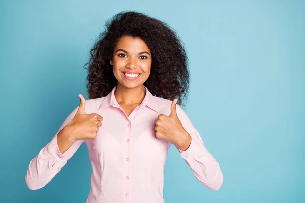 Photo of pretty wavy dark skin business lady in perfect mood raise thumbs up advising new product wear pink formalwear shirt isolated blue color background — Stock Fotó