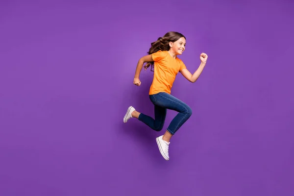 Full length body size side view of her she nice attractive glad cheerful cheery wavy-haired girl jumping running hobby free time isolated over lilac purple violet pastel color background — стоковое фото