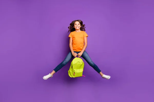 Full length body size view of her she nice attractive lovely cute playful funky cheerful wavy-haired girl jumping holding in hands bag isolated on lilac purple violet pastel color background — стоковое фото