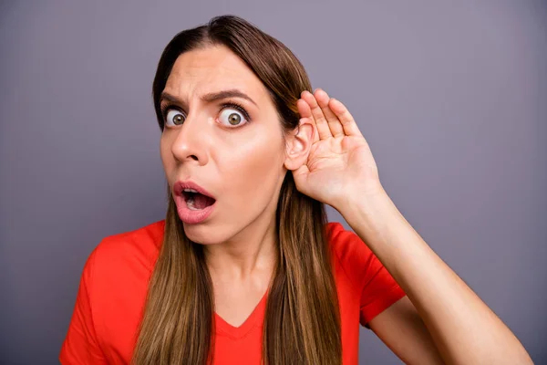 Close-up foto van gekke dame hand in hand in de buurt oor luisteren verse geruchten vroeg zich af open mond chatterbox persoon dragen casual oranje t-shirt geïsoleerde grijze kleur achtergrond — Stockfoto